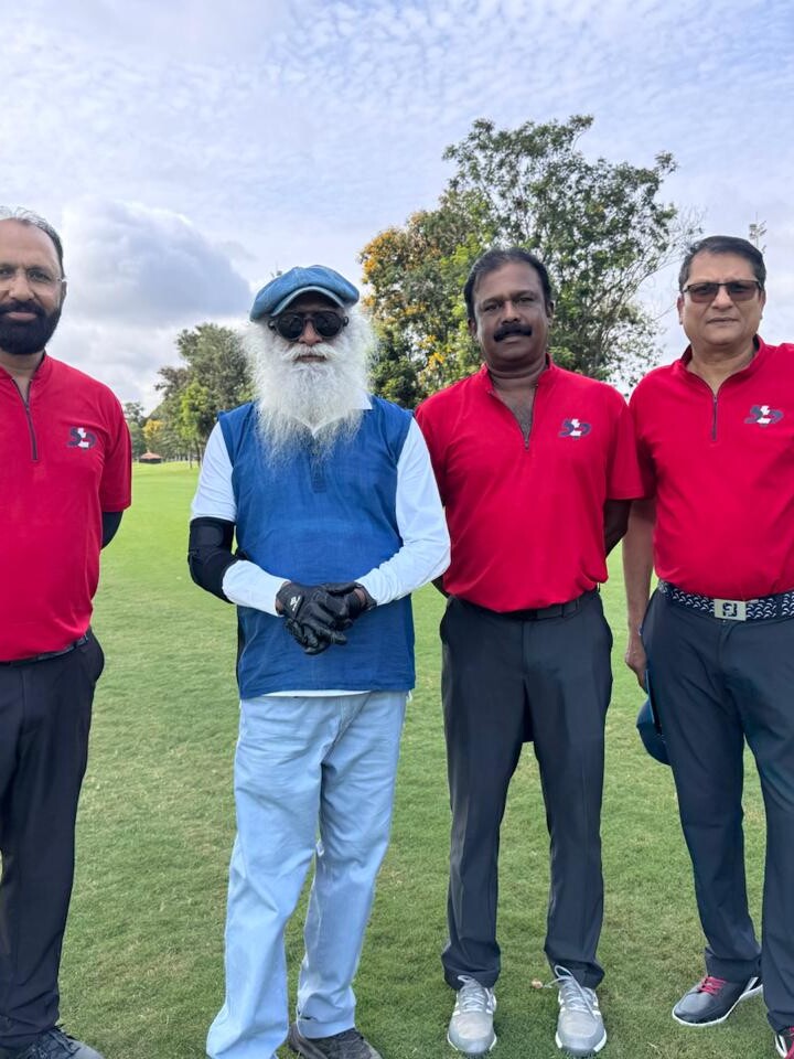 Govind Raj with golfers on a fairway