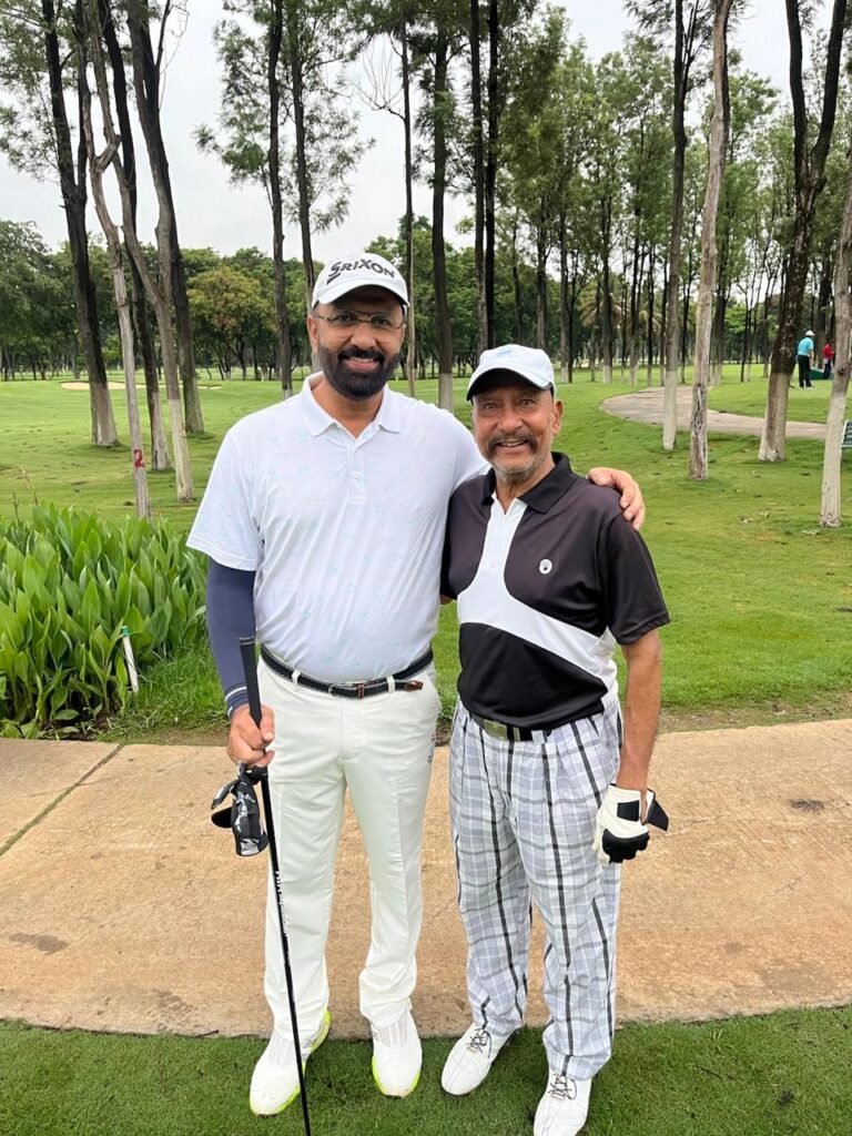 Govind Raj with a playing partner on a golf course