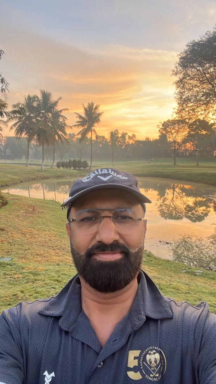 Govind Raj taking a selfie on a golf course at sunrise