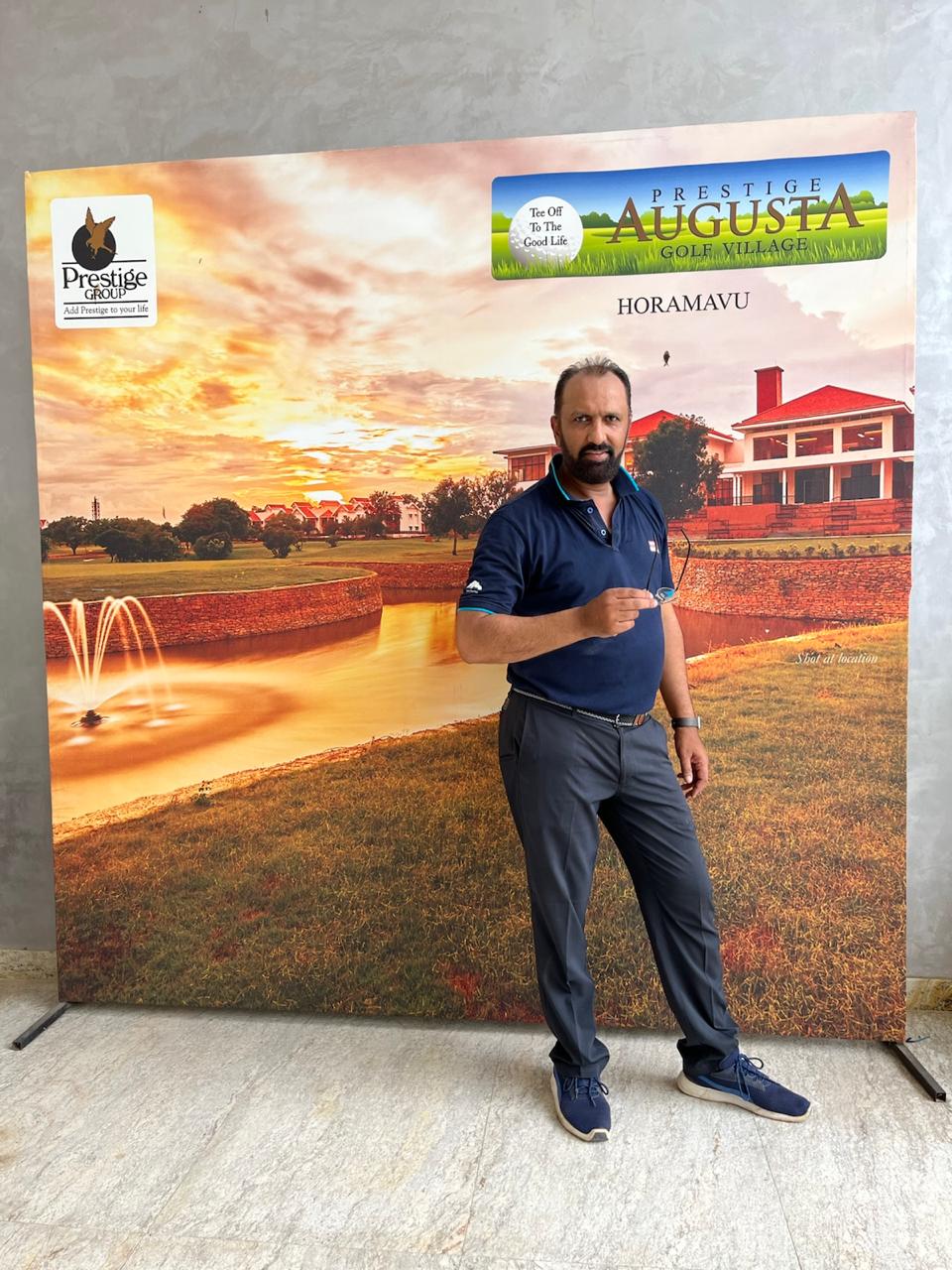 Govind Raj in front of a Prestige Augusta Golf Village display