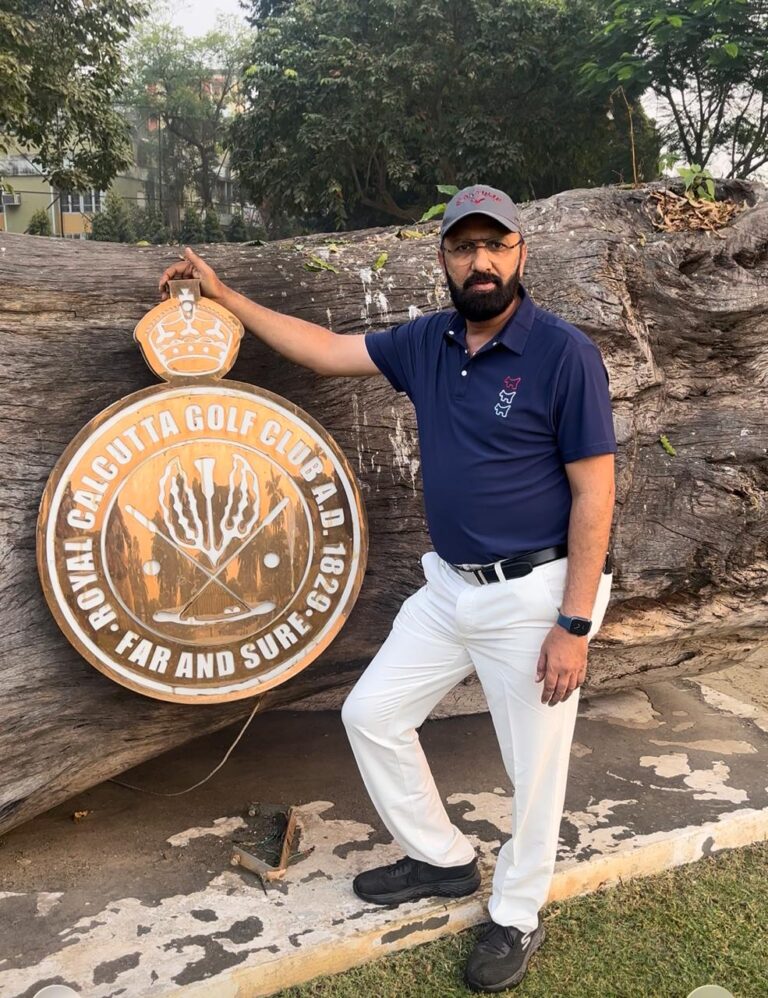 Govind Raj beside the Royal Calcutta Golf Club emblem