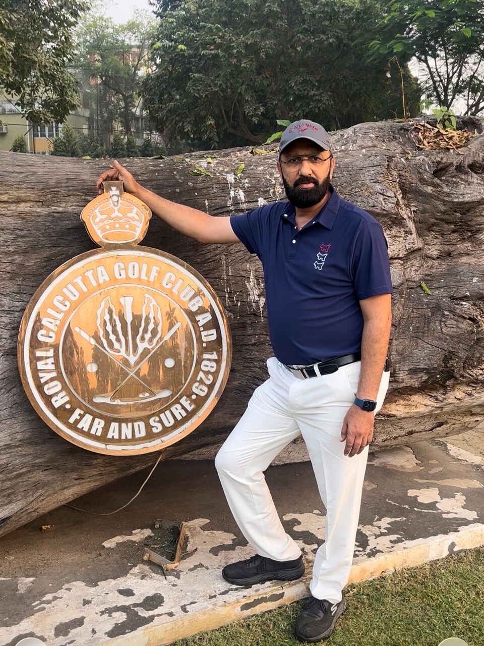 Govind Raj beside the Royal Calcutta Golf Club emblem