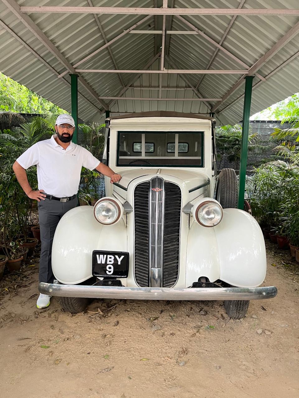 Govind Raj beside a vintage car at a golf club